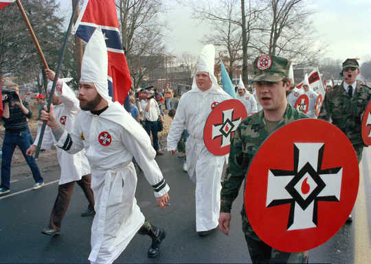 In this Jan. 18, 1986, photo, a KKK group marches in Tennessee to protest the first national observance of Martin Luther King Jr.‘s birthday.