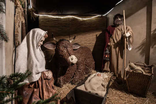 A Nativity scene showing the birth of Jesus in a manger.