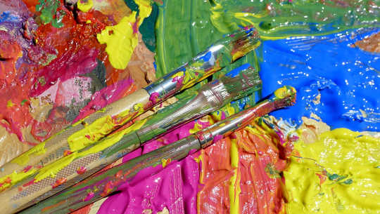 colorful palette with several paintbrushes