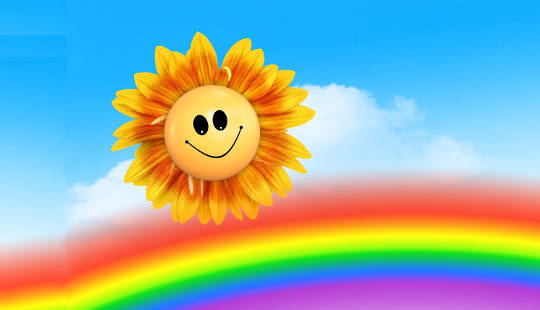 sateenkaari hymyilevällä auringonkukkakasvolla