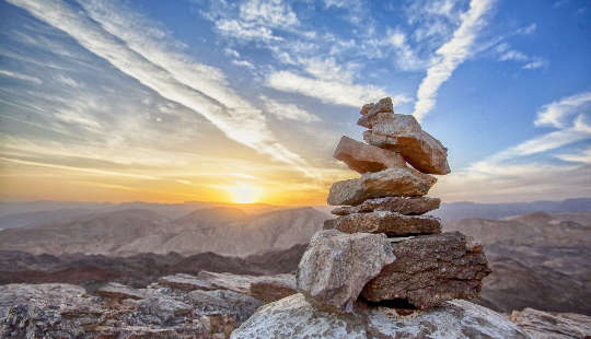 a pillar of stones that are perfectly balanced, yet appear precariously balanced