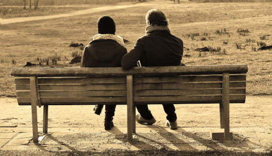 a couple sitting on a bench