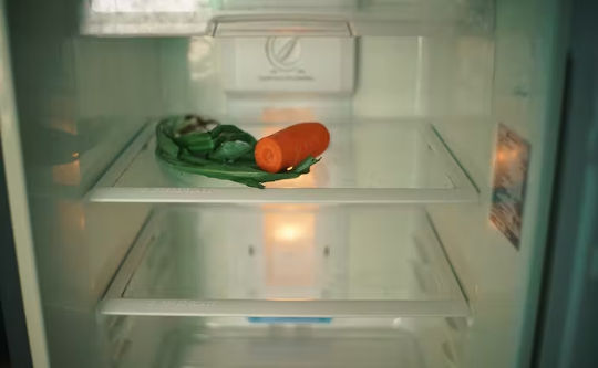 un frigorifero con pochi pezzi di cibo