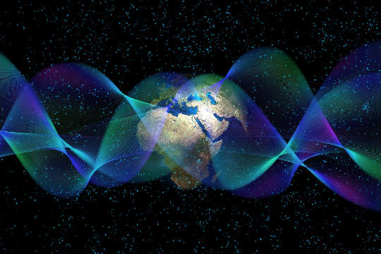 artwork of Planet Earth and quantum physics waves and particles