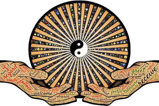 handen die een mandala vasthouden met een yin-yang symbool in het midden
