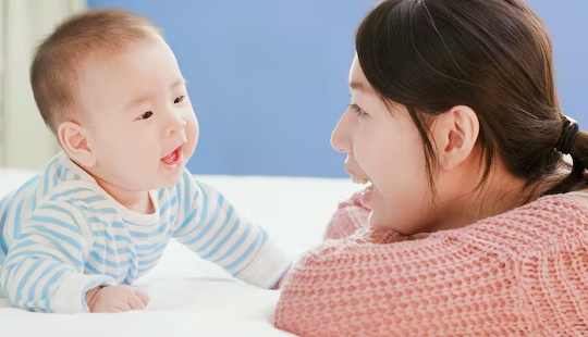 a mother talking to her baby