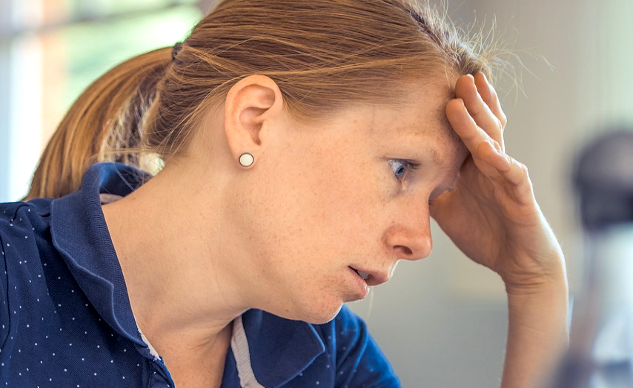 femme fatiguée avec sa main sur son front