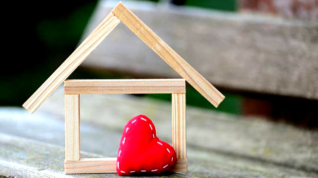 a frame of a house with a heart in front.