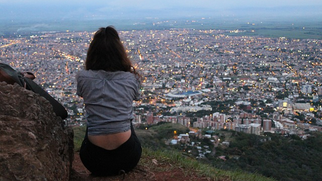 en kvinne som sitter med utsikt over en by