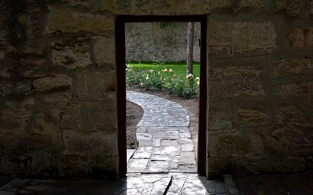 an door opening onto a pastoral scene