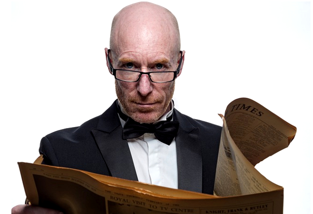 a man wearing a bow-tie and reading glasses while holding an open newspaper