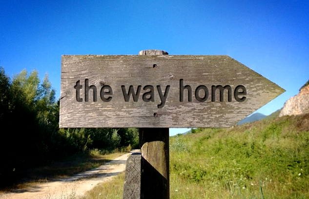 a signpost on which are written the words: "The Way Home"