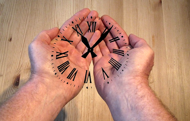 open hands with the numbers and needles of a clock superimposed on the hands