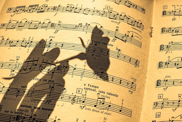 The shadow of a rose over a sheet of music. Image by Ri Butov from Pixabay. 