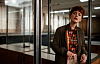 concerned-looking woman standing in an office setting