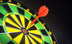a dart right in the bull's eye of a dartboard