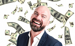 a smiling man with money falling from the skies around him