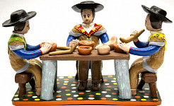 clay figurines sitting at a table eating food made of clay