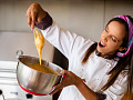 Image by jramaraljr from Pixabay. A woman chef joyfully preparing food. 