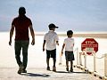 Sign warning of extreme heat danger in Death Valley during record-breaking heat waves in July 2024, highlighting climate change’s growing impact on global temperatures.