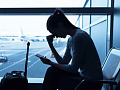 An airport terminal with travelers waiting for flights, showing the importance of having strategies to cope with flight delays and cancellations.