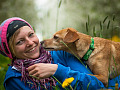A woman with a wide smile and her dog. Image by Susanne from Pixabay. 