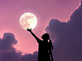A visual of a person "holding" the full moon in their hand. Image by Alem Coksa from Pixabay.