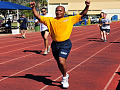 Black athlete winning the race at a track meet