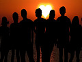 A group of people standing together in the light. Image by Enlightening Images from Pixabay. 
