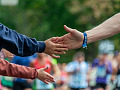 Two people shaking hands, with another person reaching out with no hand to shake. Image by alba1970 from Pixabay. 