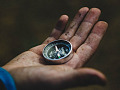 A compass in the palm of a hand. Image by dima_goroziya from Pixabay. 