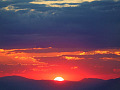 Sun rising over the mountains. Photo by Konevi. 