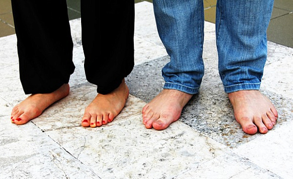 two pairs of bare feet standing firm