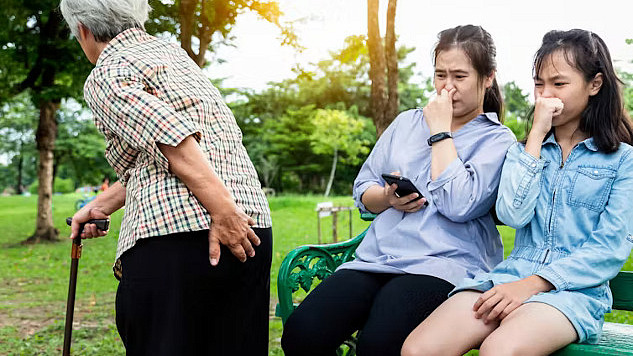 A couple taking a leisurely walk after a meal in a park.