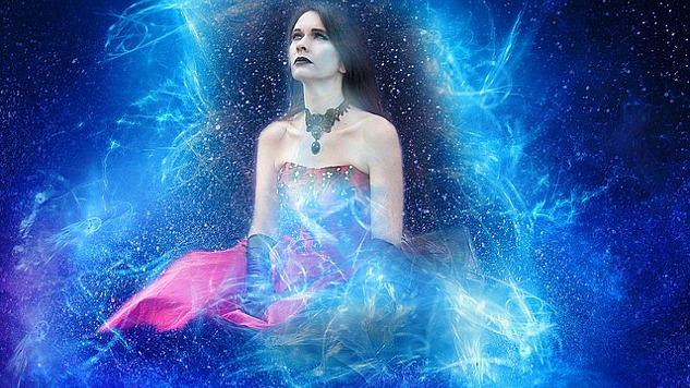 sitting woman surrounded by energy and the starry heavens