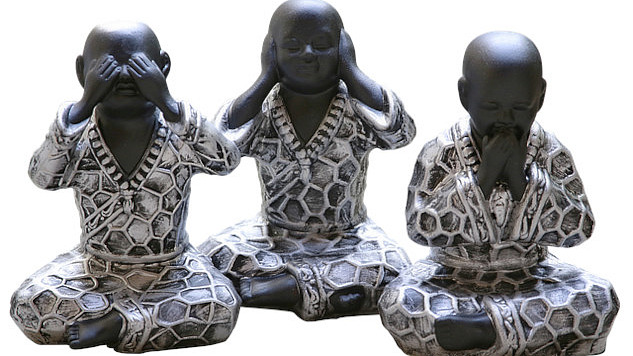 Three seated Buddhas in the classic see no evil, hear no evil, speak no evil positions