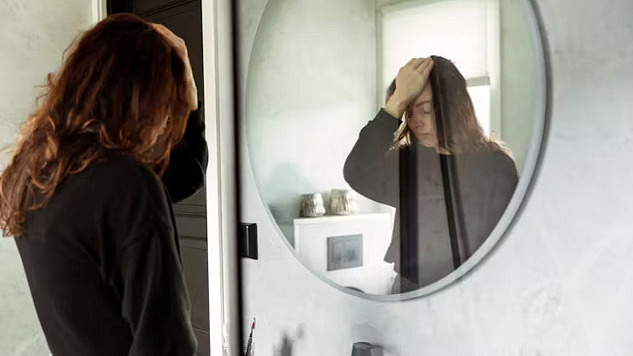 a person looking at themselves in the mirror