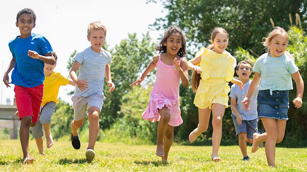 Preschoolers playing and engaging in physical activities outdoors, highlighting the importance of movement guidelines for child health and development.