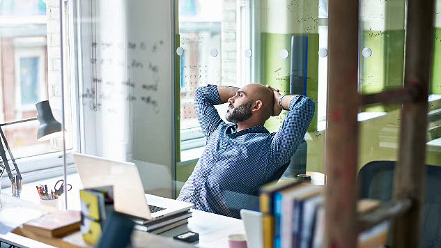 A person pausing before sharing something online, symbolizing the importance of thinking before spreading information.