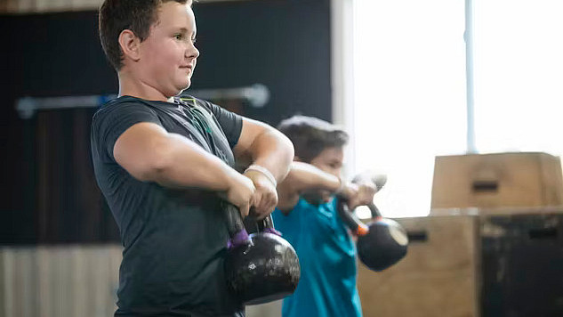 Children and teens engaged in strength training.