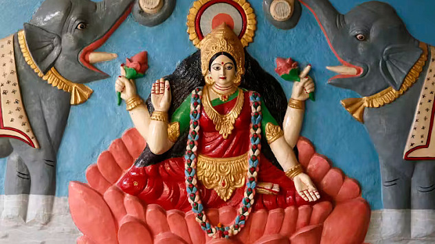 Relief of the Hindu goddess Lakshmi standing on a lotus, symbolizing purity, wisdom, and auspiciousness in Indian religious traditions.