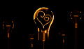 lightbulb wih the filaments inside in the shape of a heart