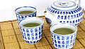 teh yang dibengkokkan dalam cawan tradisional dan teko