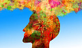 side view of a person's head filled with numerous colors and with a colorful cloud hovering above