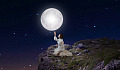 woman sitting under the full moon and stars