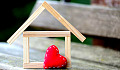 a frame of a house with a heart in front.
