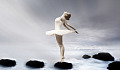 ballerina standing on rocks in water