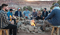 people sitting around a campfire
