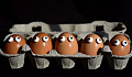 a box of eggs with googly eyes