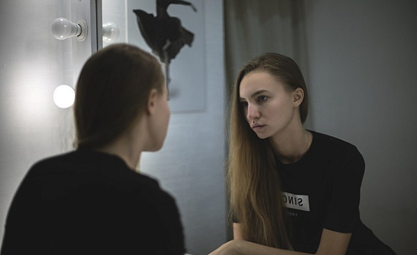 woman looking at herself in a mirror